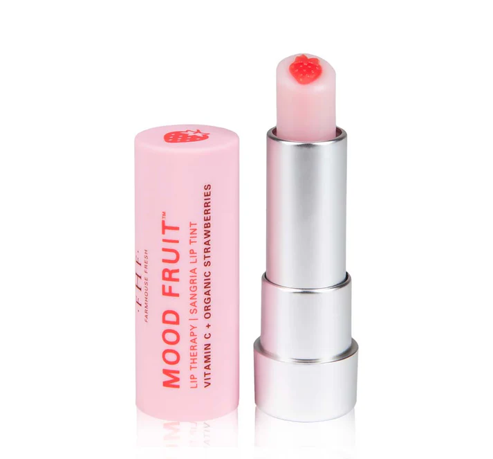 A silver lip balm tube with a pink cap and a light pink lip tint featuring a small strawberry design at the top.