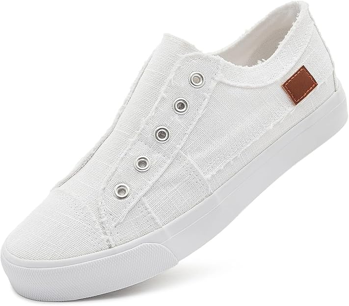 White slip‑on canvas sneaker with metal eyelets, frayed collar, white rubber sole, and a small brown heel patch.