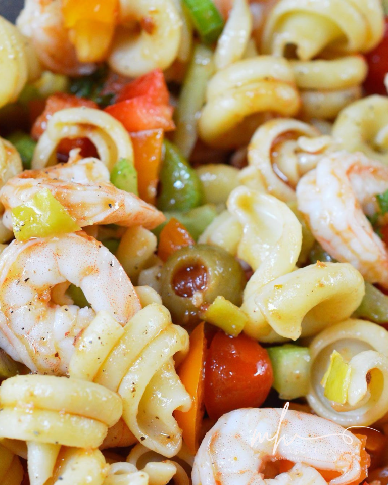 Colorful shrimp pasta salad with spiral pasta, juicy shrimp, green olives, diced bell peppers, and celery tossed in a light, savory dressing.