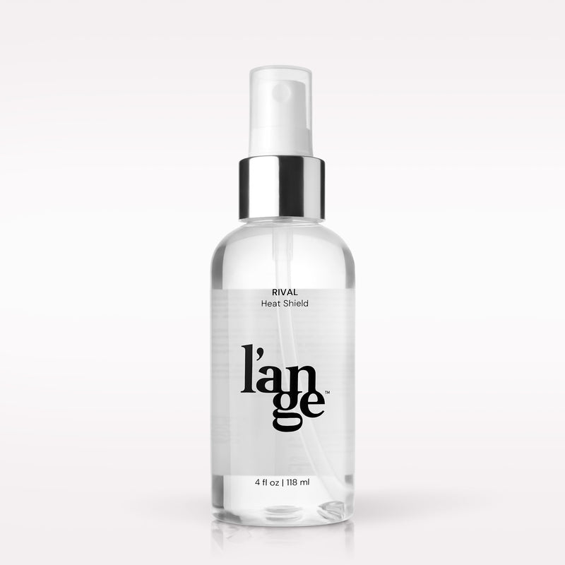 A clear spray bottle of L’ange Rival Heat Shield with a silver cap and nozzle, shown against a neutral background.