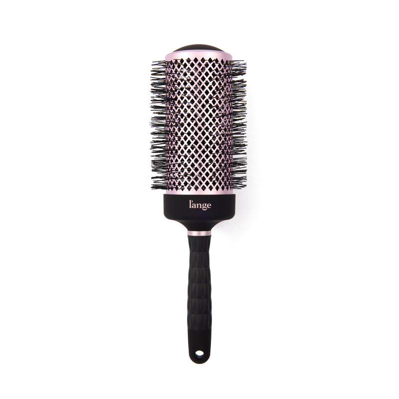 L’ange round hair brush with a pink vented barrel, black bristles, and textured black handle on a white background.