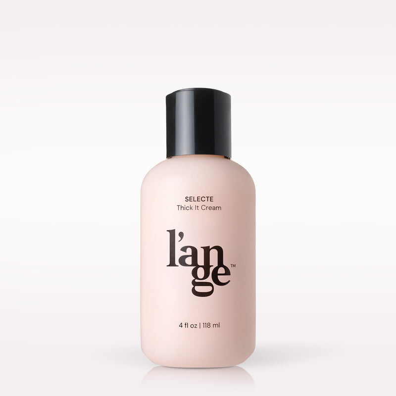 L’ange Selecte Thick It Cream in a soft blush-pink 4 oz bottle with a black cap and black L’ange logo.